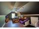 Attic bedroom featuring hardwood floors, a ceiling fan and a daybed at 547 Ellington Rd, Oxford, GA 30054