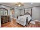 Cozy bedroom with hardwood floors, natural light, and a four-poster bed at 547 Ellington Rd, Oxford, GA 30054