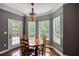 Cozy dining area with hardwood floors and a door to the outdoor deck at 547 Ellington Rd, Oxford, GA 30054