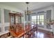 Formal dining room with hardwood floors, a large window and decorative trim work at 547 Ellington Rd, Oxford, GA 30054