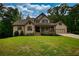 Charming two-story home with a covered front porch and a well-manicured lawn at 547 Ellington Rd, Oxford, GA 30054