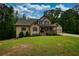 Charming two-story home with a covered front porch and a well-manicured lawn at 547 Ellington Rd, Oxford, GA 30054