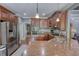 Gourmet kitchen with granite countertops, stainless steel appliances, and wood cabinets at 547 Ellington Rd, Oxford, GA 30054