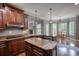 Eat-in kitchen with granite countertops and wooden cabinetry with a view of the dining area at 547 Ellington Rd, Oxford, GA 30054