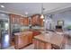 Spacious kitchen with granite countertops, wooden cabinets, and stainless steel appliances at 547 Ellington Rd, Oxford, GA 30054