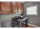 Functional laundry room equipped with modern washer, dryer, and ample overhead cabinetry at 547 Ellington Rd, Oxford, GA 30054