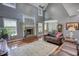 Open living room with large windows, a fireplace, and hardwood floors at 547 Ellington Rd, Oxford, GA 30054