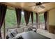 Cozy screened porch with comfortable seating, ceiling fan and views of the backyard at 547 Ellington Rd, Oxford, GA 30054