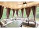 Inviting screened porch with comfortable seating, ceiling fan and views of the wooded backyard at 547 Ellington Rd, Oxford, GA 30054