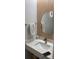 Modern bathroom with a round mirror, light wood accents, and a sleek vanity at 1805 Ashborough Se Cir # D, Marietta, GA 30067
