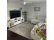 Stylish living room with a large TV, comfortable seating, and a ceiling fan at 1805 Ashborough Se Cir # D, Marietta, GA 30067