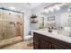 Stylish bathroom with tiled shower, dark wood vanity, updated fixtures, and a framed mirror at 1965 Stilesboro Nw Dr, Kennesaw, GA 30152