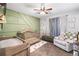 Charming Bedroom with green accent wall, crib, changing table, and comfortable seating at 1965 Stilesboro Nw Dr, Kennesaw, GA 30152