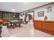 Spacious billiard room with a pool table, wet bar, and tile flooring throughout at 1965 Stilesboro Nw Dr, Kennesaw, GA 30152