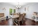 Light-filled dining room boasts wood floors, stylish chandelier, and French door access to backyard at 1965 Stilesboro Nw Dr, Kennesaw, GA 30152