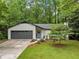 Beautifully landscaped single-story home with an attached garage and inviting front entrance at 1965 Stilesboro Nw Dr, Kennesaw, GA 30152
