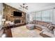 Open living room with stone fireplace, plush seating, and large windows for natural light at 1965 Stilesboro Nw Dr, Kennesaw, GA 30152