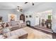 Bright living room featuring plush seating, wood floors, and seamless transition to dining area at 1965 Stilesboro Nw Dr, Kennesaw, GA 30152