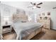Cozy main bedroom featuring a ceiling fan, carpet flooring, and a neutral color palette at 1965 Stilesboro Nw Dr, Kennesaw, GA 30152