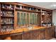 Finished basement wet bar features custom wooden cabinetry and plenty of storage for glassware at 1965 Stilesboro Nw Dr, Kennesaw, GA 30152