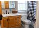 Well-lit bathroom featuring an oak vanity, modern fixtures, and black-and-white shower curtain at 4076 Airline, Mcdonough, GA 30252