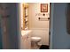 Cozy bathroom with white wainscoting, neutral colors, and decorative shelving at 4076 Airline, Mcdonough, GA 30252