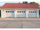 Three-car garage with white doors and ample parking space on the concrete driveway at 4076 Airline, Mcdonough, GA 30252