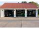 Well-equipped garage gym with three doors, gym equipment, and sleek Mopar accents at 4076 Airline, Mcdonough, GA 30252