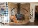 Cozy living room with a stone fireplace and rustic decor, including rifles mounted on the wall at 4076 Airline, Mcdonough, GA 30252
