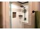 Modern tiled shower featuring a sleek shower head, built-in niche, and glass partition at 4076 Airline, Mcdonough, GA 30252