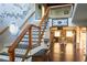 Elegant staircase with wood railing, decorative accents, and open floor plan view at 4076 Airline, Mcdonough, GA 30252