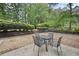 Serene backyard with a stone fire pit, patio, and seating, enhanced by mature landscaping at 4468 Whitt Station Nw Run, Acworth, GA 30101