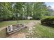 Expansive backyard featuring a charming shed, garden bed, and lush greenery at 4468 Whitt Station Nw Run, Acworth, GA 30101
