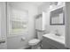 Bright bathroom featuring beadboard paneling, a modern vanity, and a stylish mirror above the sink at 4468 Whitt Station Nw Run, Acworth, GA 30101