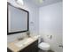 Cozy bathroom includes white toilet and sink with tan granite vanity and light blue walls at 4468 Whitt Station Nw Run, Acworth, GA 30101