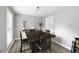 Neutral dining room features gray walls and a large wooden table with cushioned chairs at 4468 Whitt Station Nw Run, Acworth, GA 30101