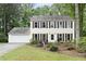 Charming two-story home with brown shutters, attached two-car garage, and a landscaped front yard at 4468 Whitt Station Nw Run, Acworth, GA 30101