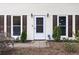 Close up of the front door, with sidelight windows, stylish lighting, and landscaping at 4468 Whitt Station Nw Run, Acworth, GA 30101