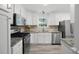 Well-lit kitchen boasts stainless steel appliances, light granite countertops and ample cabinet space at 4468 Whitt Station Nw Run, Acworth, GA 30101
