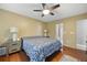 Lovely main bedroom features hardwood floors, a ceiling fan, and warm lighting at 4468 Whitt Station Nw Run, Acworth, GA 30101