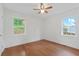 Bright bedroom with hardwood floors, a ceiling fan, and natural light from two windows at 472 Rigby Ne St, Marietta, GA 30060