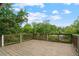 Expansive wooden deck with a scenic view of lush green trees and a bright blue sky at 472 Rigby Ne St, Marietta, GA 30060