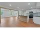 Open-concept kitchen showcasing island with dark counter, stainless appliances, and a bright living area at 472 Rigby Ne St, Marietta, GA 30060