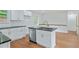 A modern kitchen with white cabinets, stainless steel appliances, and a center island at 472 Rigby Ne St, Marietta, GA 30060