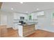 Updated kitchen featuring white cabinets, stainless steel appliances, and wood-accented island at 472 Rigby Ne St, Marietta, GA 30060