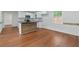 Modern kitchen featuring white cabinets, black countertops, stainless steel appliances, and wood-accented island at 472 Rigby Ne St, Marietta, GA 30060