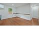 Bright living room with hardwood floors, a window, and a modern aesthetic with white walls at 472 Rigby Ne St, Marietta, GA 30060