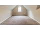 Bright attic space featuring carpet flooring and a dormer window at 6416 Vicksburg Nw Ct, Acworth, GA 30101