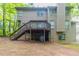 Back exterior view featuring a wooden deck with steps leading to the spacious yard, ideal for outdoor enjoyment at 6416 Vicksburg Nw Ct, Acworth, GA 30101