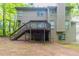 Back exterior view featuring a wooden deck with steps leading to the spacious yard, ideal for outdoor enjoyment at 6416 Vicksburg Nw Ct, Acworth, GA 30101